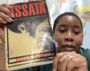 Fayola Fair holds up Assata Shakur's autobiography